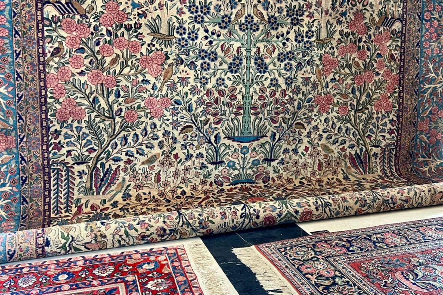 Beige Persian carpet with intricate floral designs by Carpet Cellar